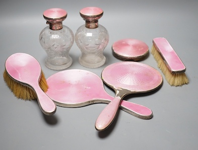 A George silver and enamel mounted glass part dressing table set, by Henry Clifford Davis and a similar American hand mirror.